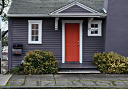 front of blue house with red door