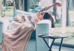 woman very comfortable at home in an arm chair 