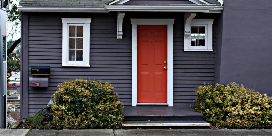 front of blue house with red door