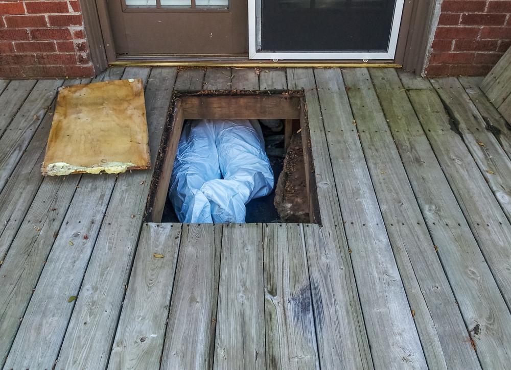 man in crawlspace