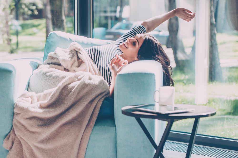 woman very comfortable at home in an arm chair