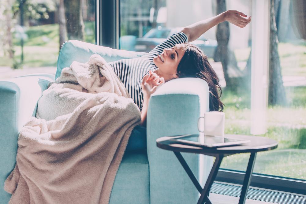 woman very comfortable at home in an arm chair 